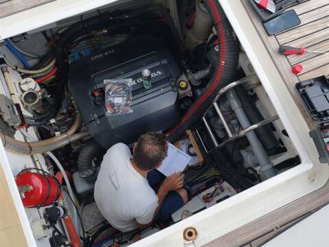 Technician servicing a yacht engine room – SailorOne
