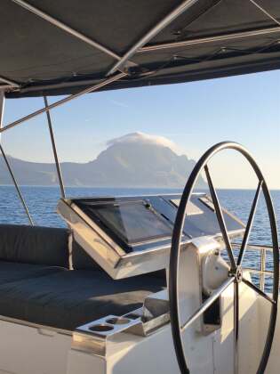 View from the helm during a transfer along the Sicilian coast – SailorOne