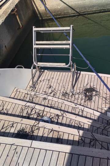 Weathered grey teak on a yacht stern before restoration – SailorOne