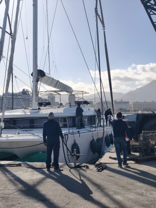 Yard team preparing a catamaran for lifting – SailorOne